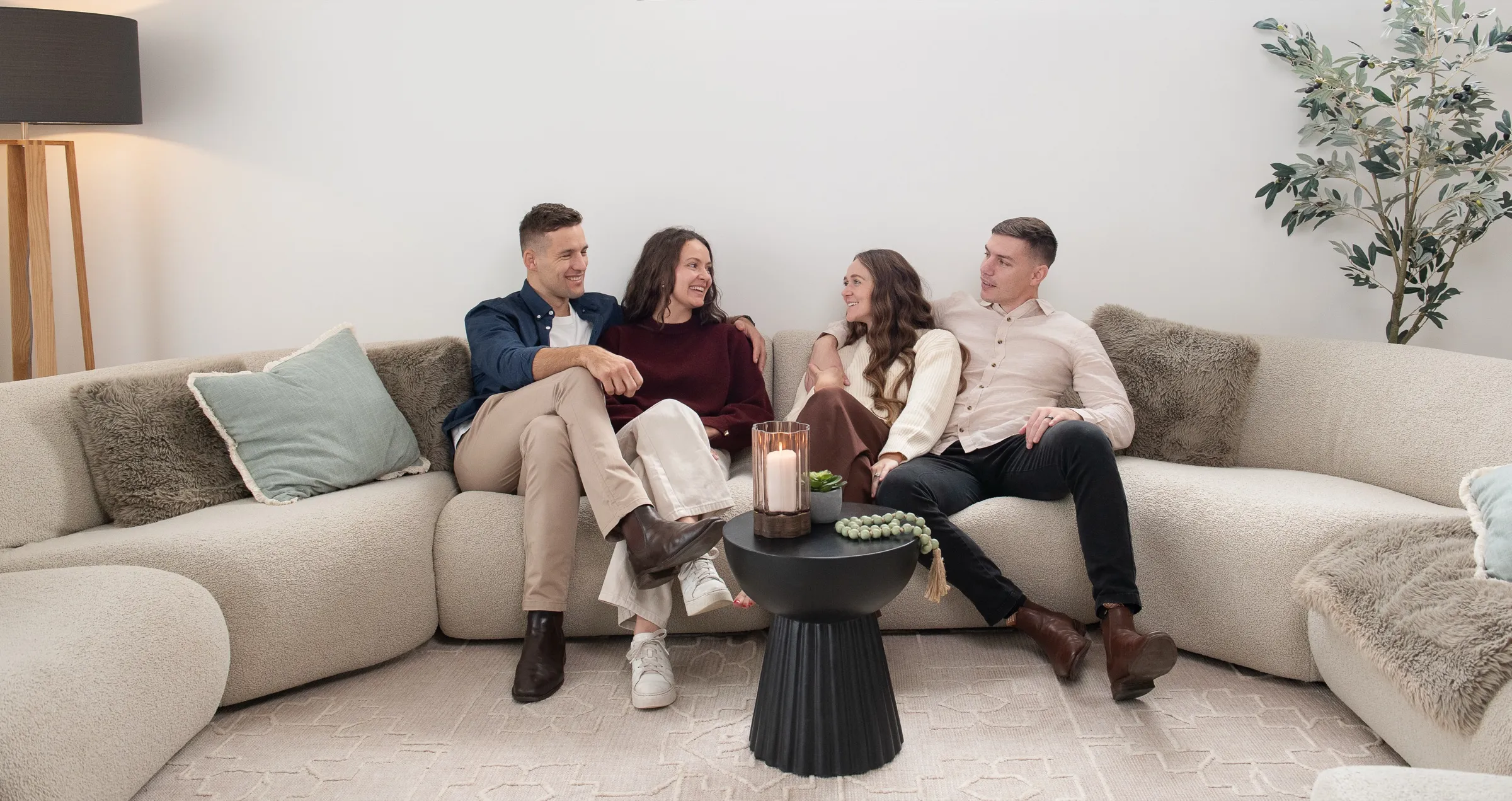 Friends chatting on a sofa — Dornford Building Group