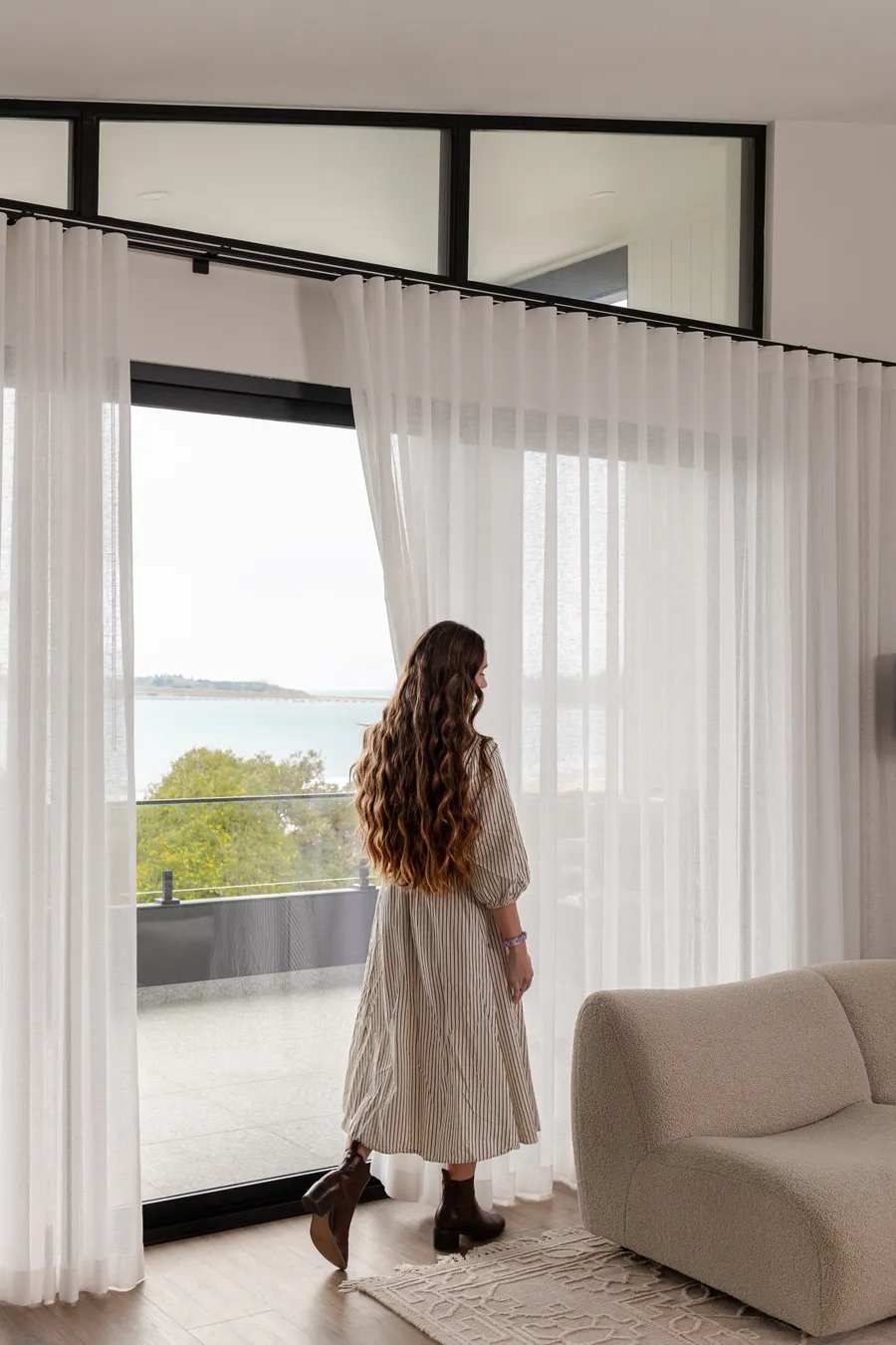 Bright custom home interior with natural light through curtains